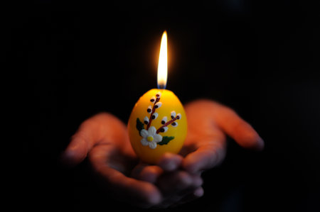 Easter candle in the hands

