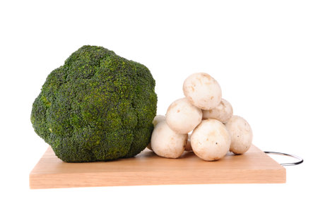 mushrooms brocolli on the cutting board isolated on the white backgroundの写真素材