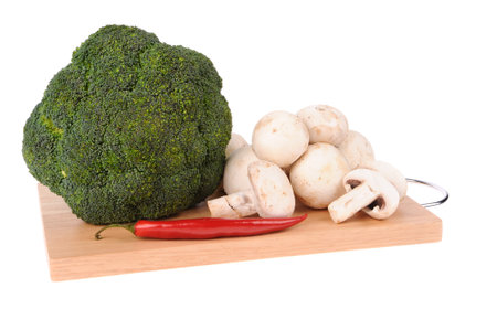 mushrooms brocolli pepper on the cutting board isolated on the white backgroundの写真素材