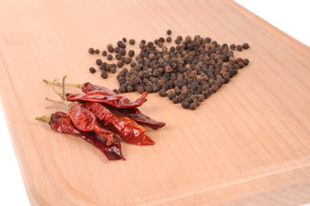 Black pepper on the wooden cutting boardの写真素材