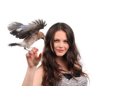 Portrait of smiling girl with bird on the handの写真素材