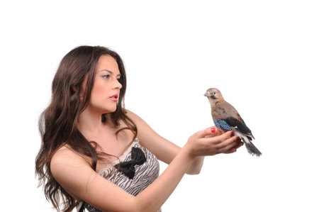 Portrait of beautiful girl with bird on the handの写真素材
