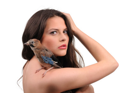 Portrait of beautiful girl with bird on the handの写真素材