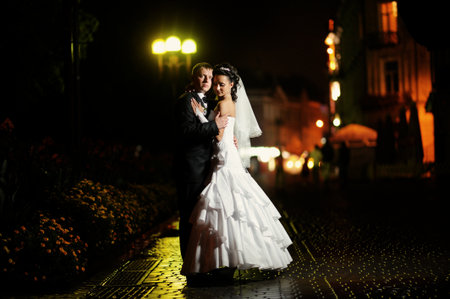 Bride and groom together at night walkの写真素材