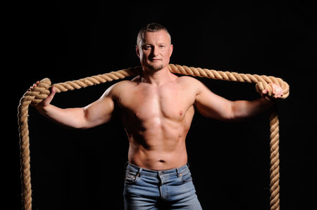Muscular male posing on black backgroundの写真素材
