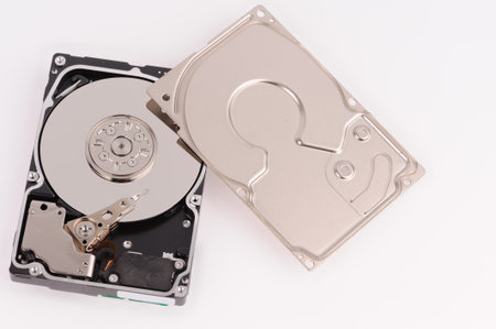 opened  hard disk drive on grey background 