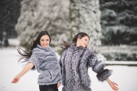 funny girls enjoying winter weather  - with film effect with small grainの写真素材