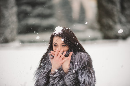 winter portrait of Beauty girl with snow - with film effect with small grainの写真素材