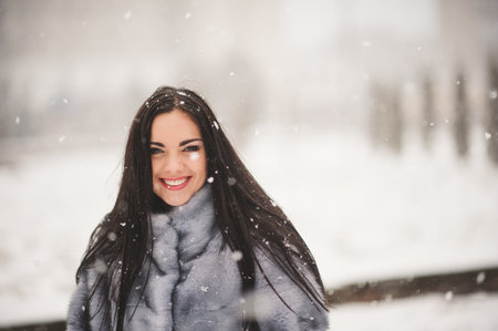 winter portrait of Beauty girl with snow - with film effect with small grainの写真素材