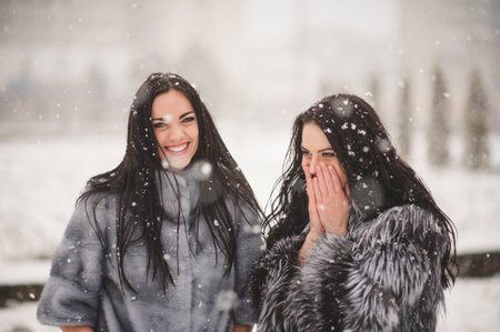 funny girls enjoying winter weather  - with film effect with small grainの写真素材