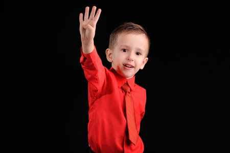 Portrait of emotionally kid. Emotional boy on the black backgroundの写真素材