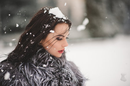 winter portrait of Beauty girl with snow - with film effect with small grainの写真素材