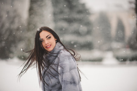 winter portrait of Beauty girl with snow - with film effect with small grainの写真素材