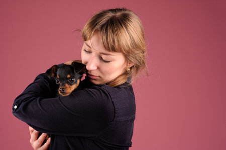 girl with puppy on the handsの写真素材