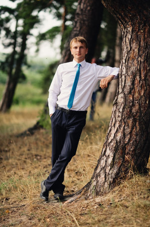 Handsome groom at wedding coat smiling and waiting for brideの写真素材
