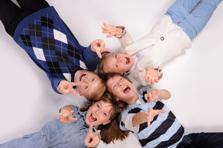 children lying on the floor isolated over white backgroundの写真素材