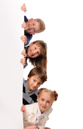 Portrait of happy children with white blank isolated on white backgroundの写真素材