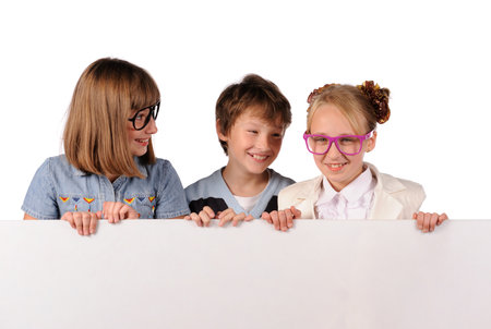 Portrait of happy children with white blank isolated on white backgroundの写真素材