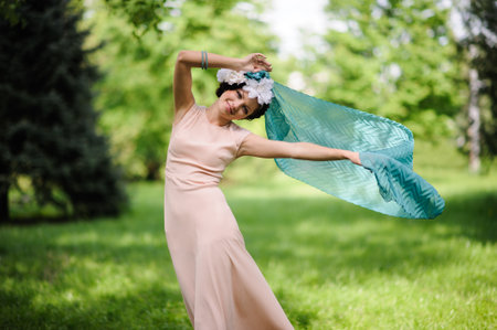 Beautiful portrait of woman in the green gardenの写真素材