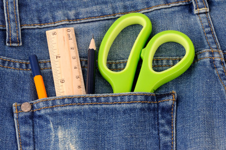 Scissors ruler  and pencil in  the blue jeans back pocketの写真素材