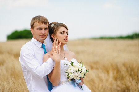 Happy bride and groom on the wheat fieldの写真素材