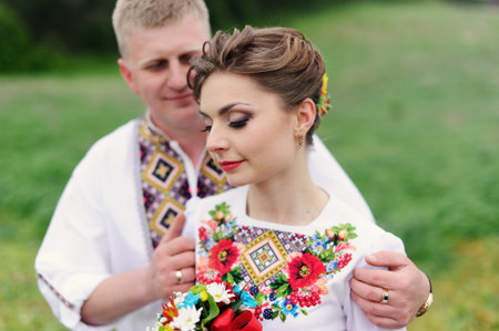 Portrait of affectionate couple with 
bouquet of flowersの写真素材