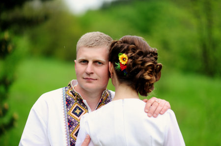 Portrait of affectionate couple with 
bouquet of flowersの写真素材