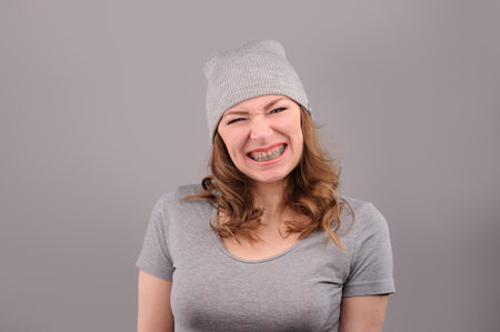 woman with funny face on grey backgroundの写真素材