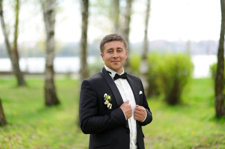 Handsome groom in white shirt  waiting for brideの写真素材