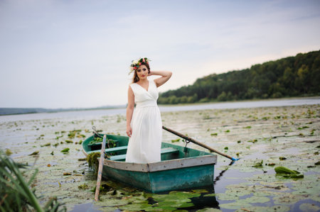 Sexy woman in white dress on the boatの写真素材