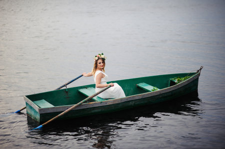 Sexy woman in white dress on the boatの写真素材
