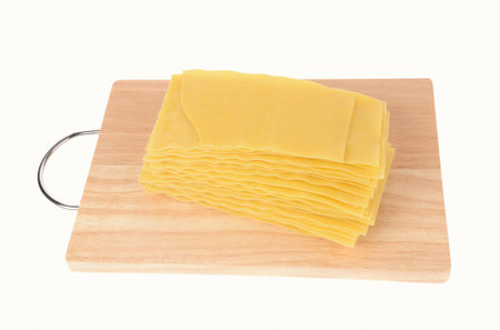 Lasagna pasta on cutting board isolated on white backgroundの写真素材