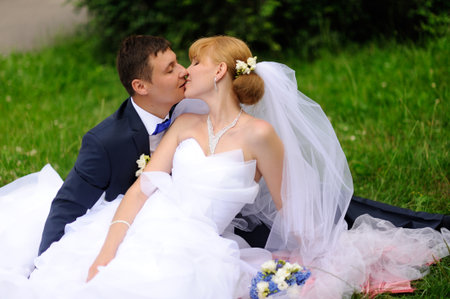 Happy bride and groom kiss on their wedding dayの写真素材