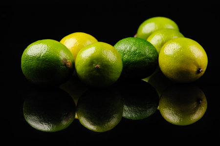 green and yellow lemons on the black backgroundの写真素材