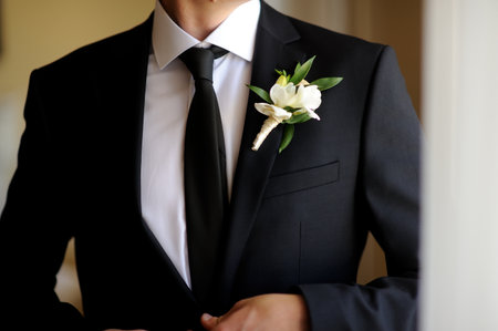 Handsome groom at wedding coat smiling and waiting for brideの写真素材