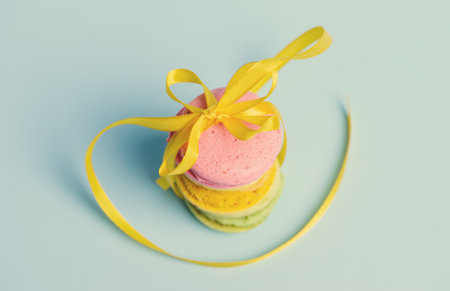 Sweet and colourful french macaroons or macaron on blue backgroundの写真素材