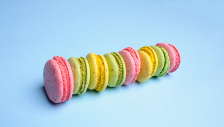 Sweet and colourful french macaroons or macaron on blue background