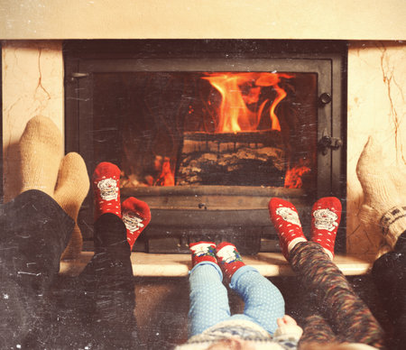 Family Warming Feet By Fireの写真素材