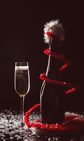 Champagne glasses set on black background with snowの写真素材