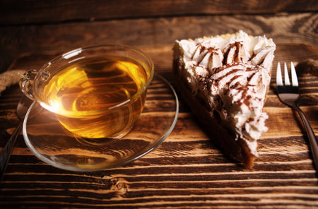 cake with tea on wooden deskの写真素材