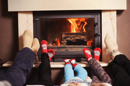 Family Warming Feet By Fireの写真素材