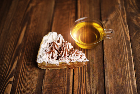 cake with tea on wooden deskの写真素材