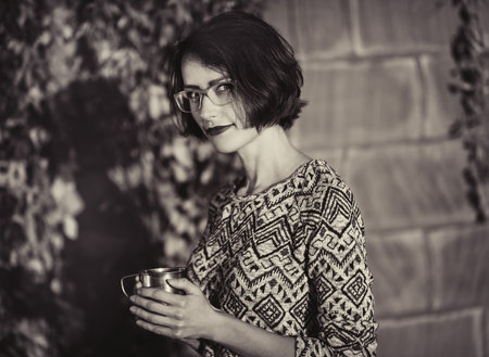 Beautiful Autumn Woman on Yellow Leaves Background Outdoorsの写真素材