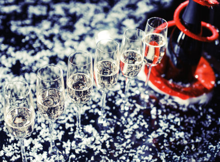 Champagne glasses set on black background with snow