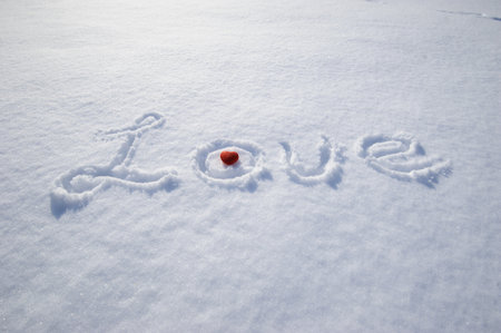word love and red heart on snowの写真素材