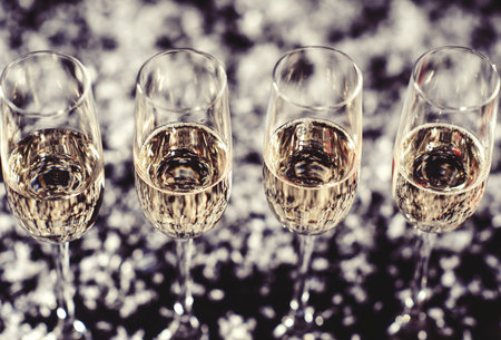 Champagne glasses set on black background with snowの写真素材