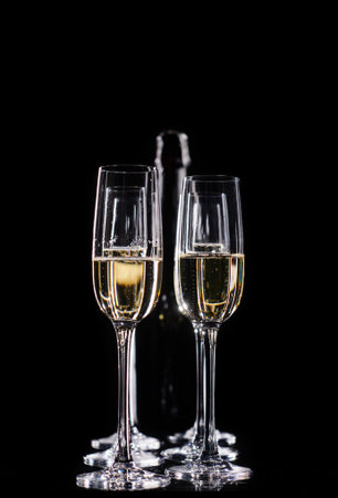 Champagne glasses set on black backgroundの写真素材