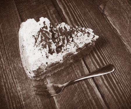 cake with dessert fork on wooden deskの写真素材