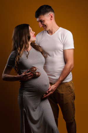 Beautiful young couple on yellow backgroundの写真素材