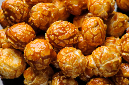 sweet Caramel Cream popcorn on the black background. Close-up picture, macro detailsの写真素材